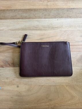 Calvin Klein Dark Brown almost maroon like Leather Wristlet Pouch with Gold Logo
